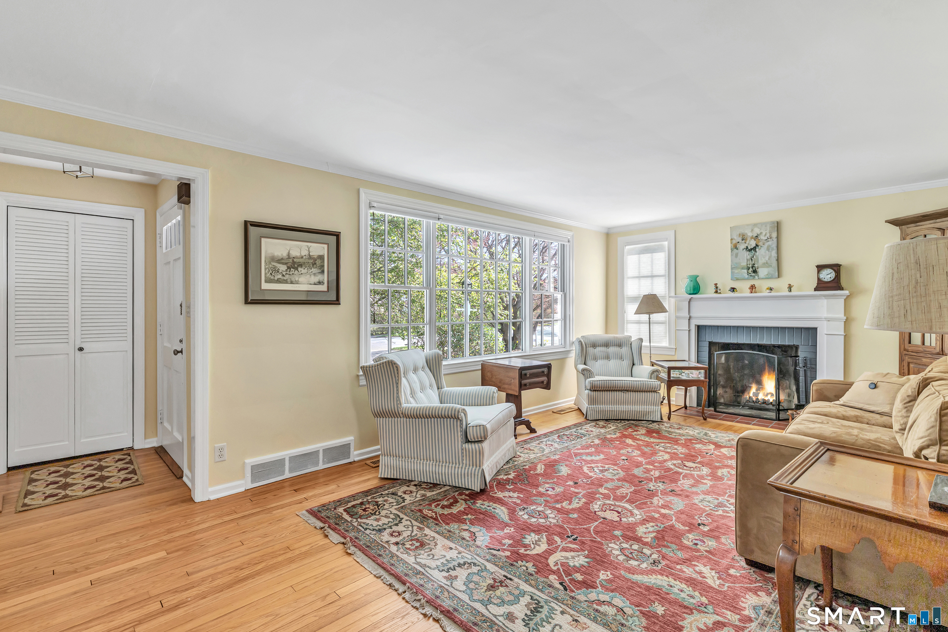 364 Beach Road Fairfield, CT 06824 - Photo 16 of 40 a living room with furniture and a fireplace