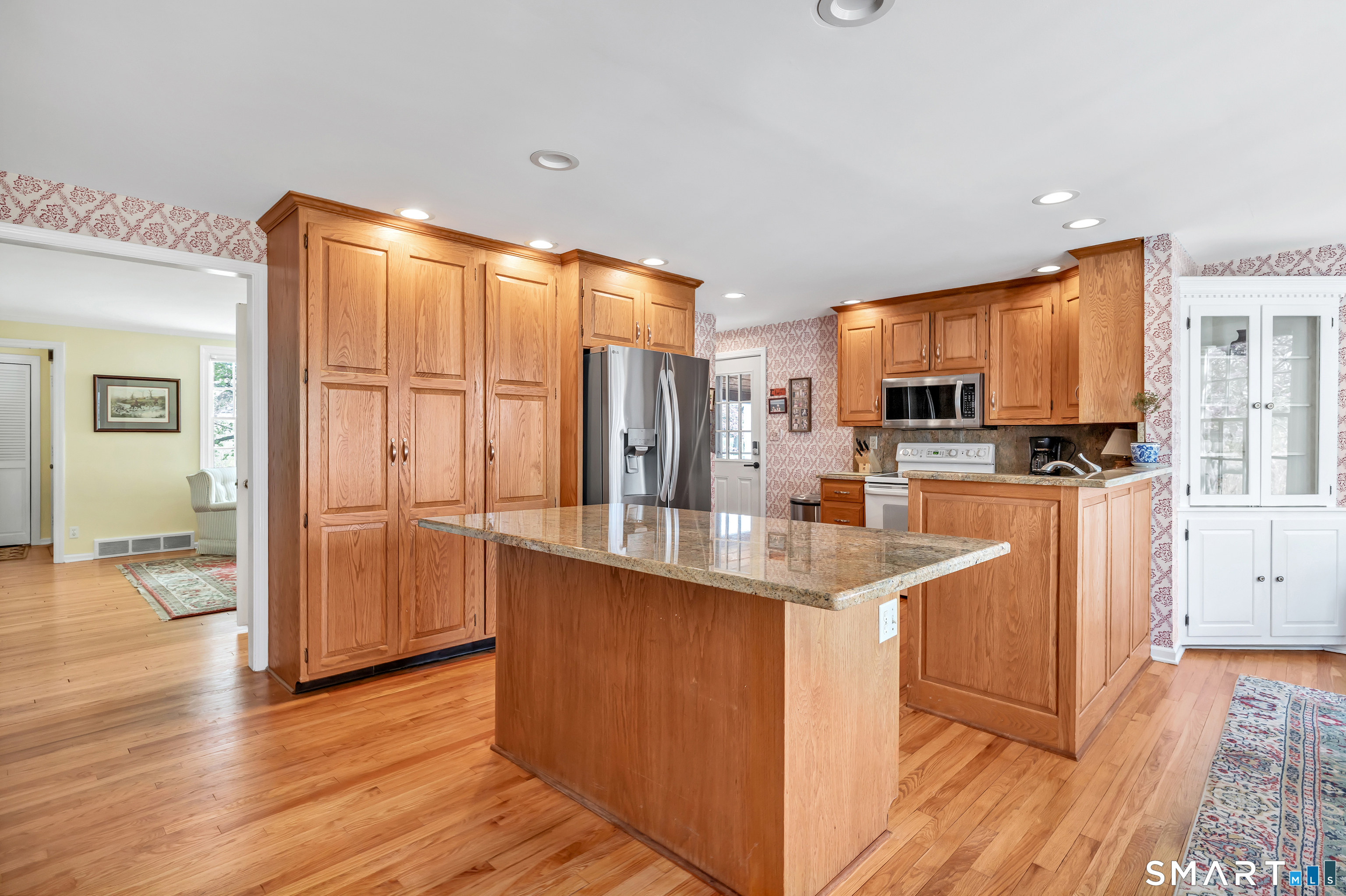 364 Beach Road Fairfield, CT 06824 - Photo 20 of 40 a kitchen with stainless steel appliances granite countertop a sink stove and refrigerator
