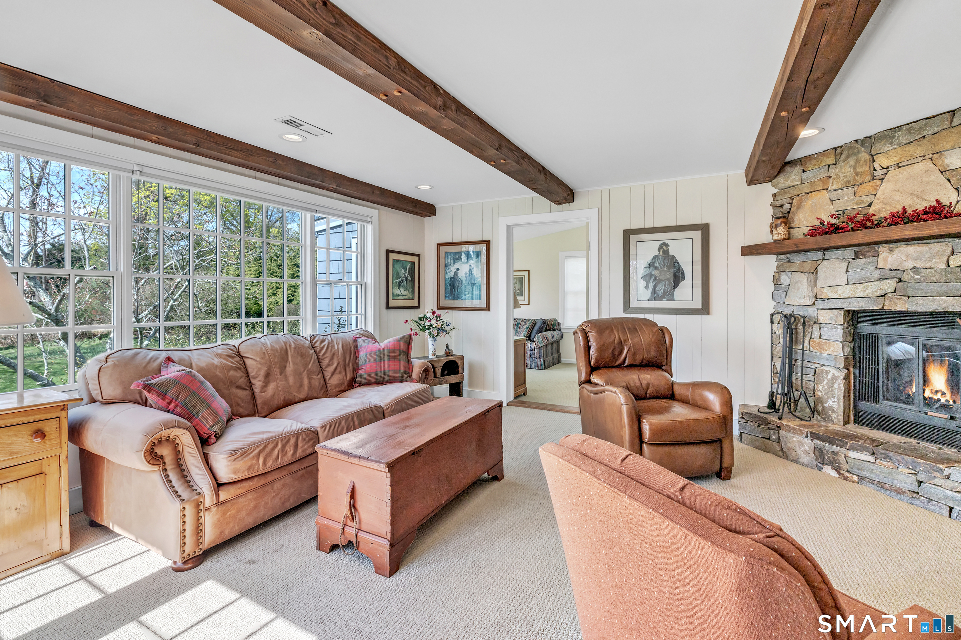 364 Beach Road Fairfield, CT 06824 - Photo 25 of 40 a living room with furniture and a fireplace