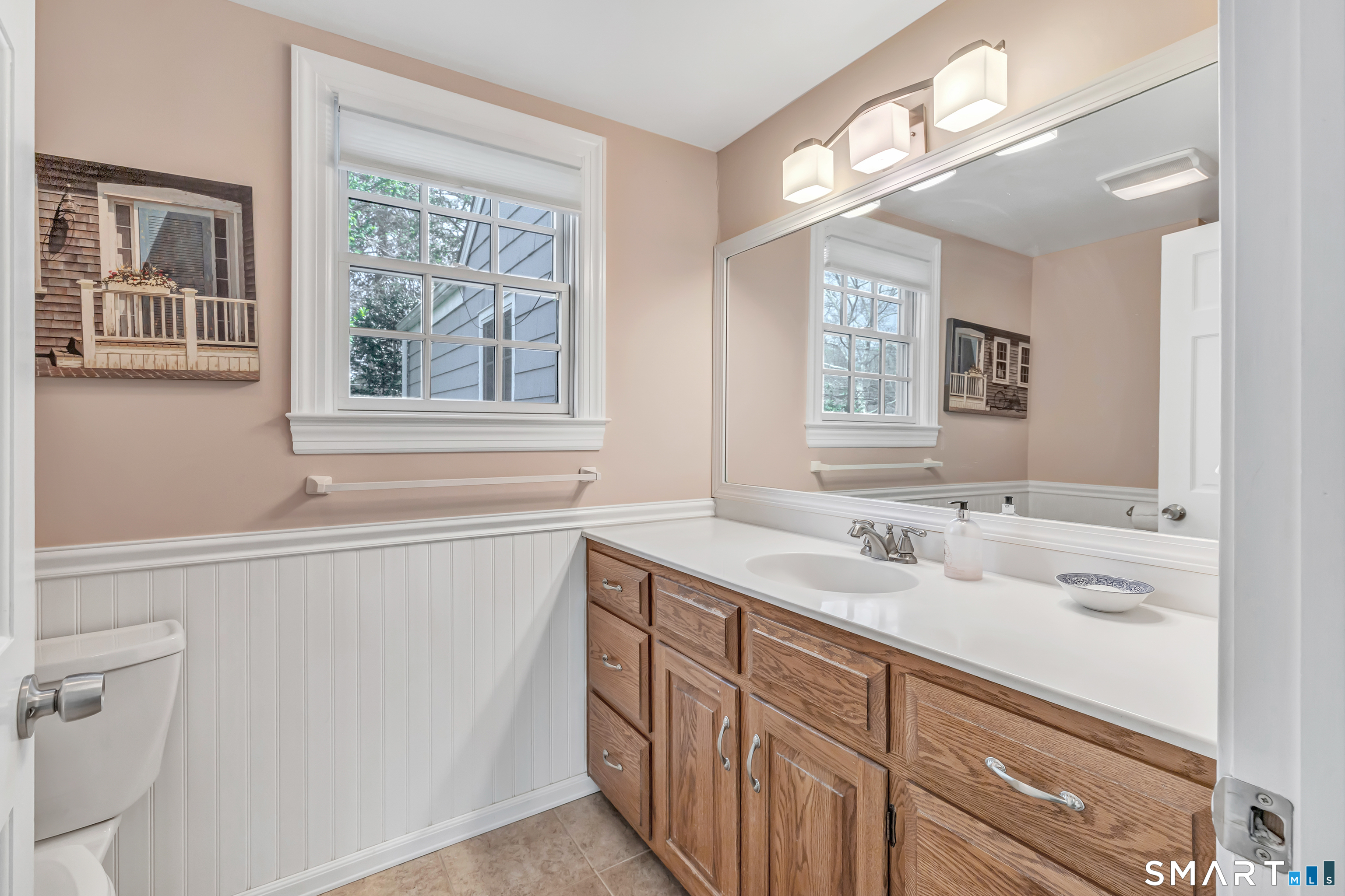 364 Beach Road Fairfield, CT 06824 - Photo 33 of 40 a bathroom with a sink and a window