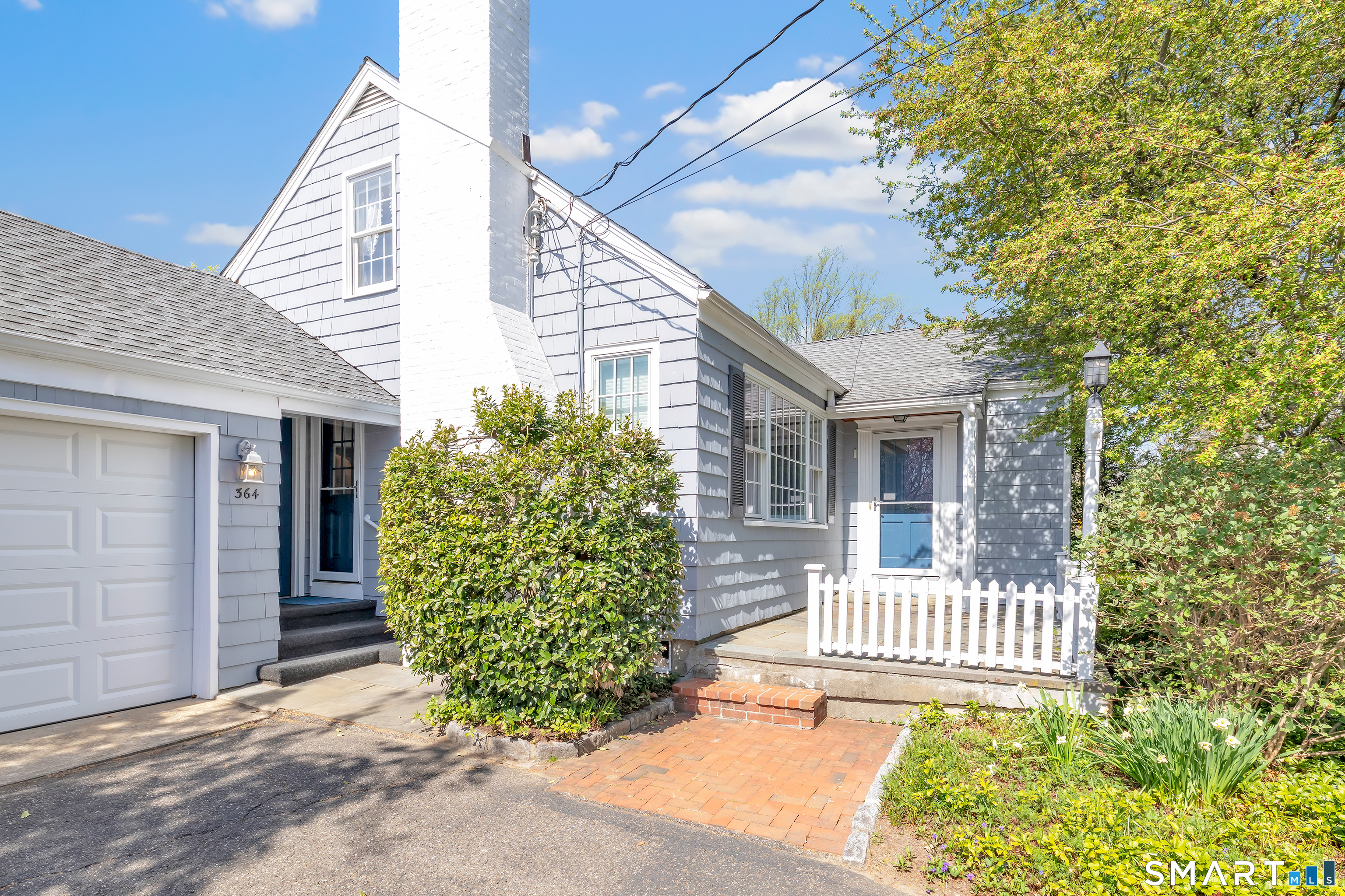 364 Beach Road Fairfield, CT 06824 - Photo 6 of 40 a front view of a house with a garden