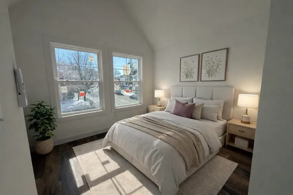 a bedroom with a large bed and a window