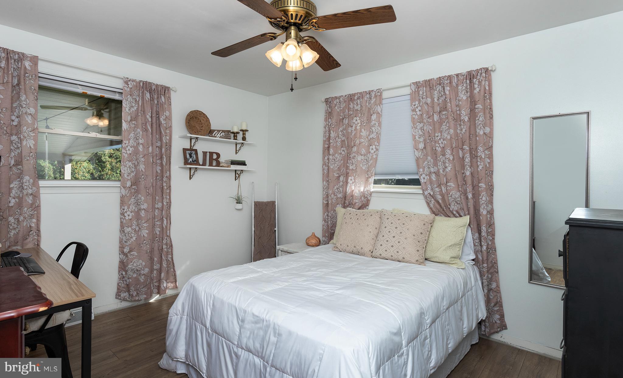 66 Runyon Road Hummelstown, PA 17036 - Photo 15 of 26 a bedroom with a bed and a chandelier