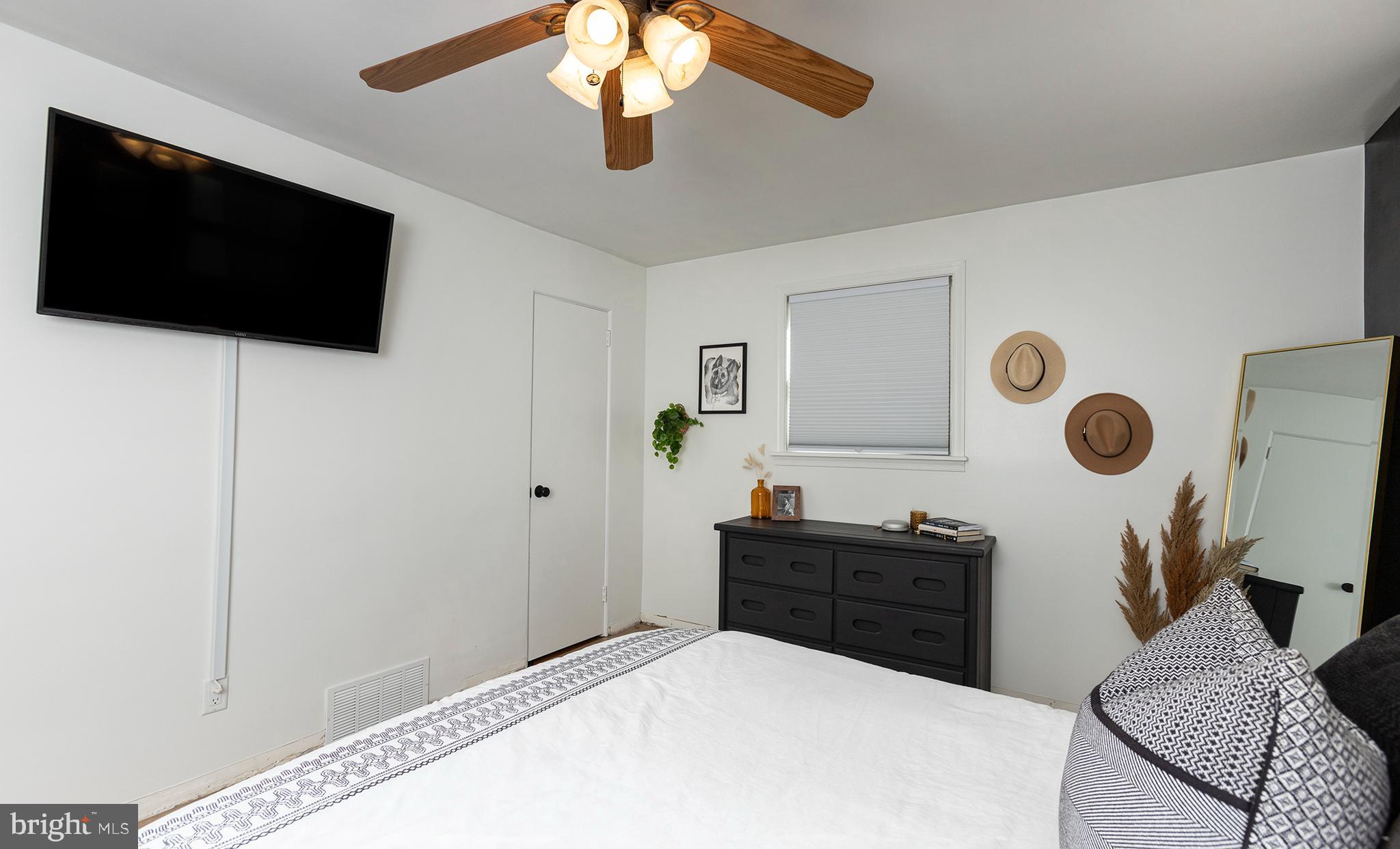 66 Runyon Road Hummelstown, PA 17036 - Photo 17 of 26 a bedroom with a bed and a flat screen tv