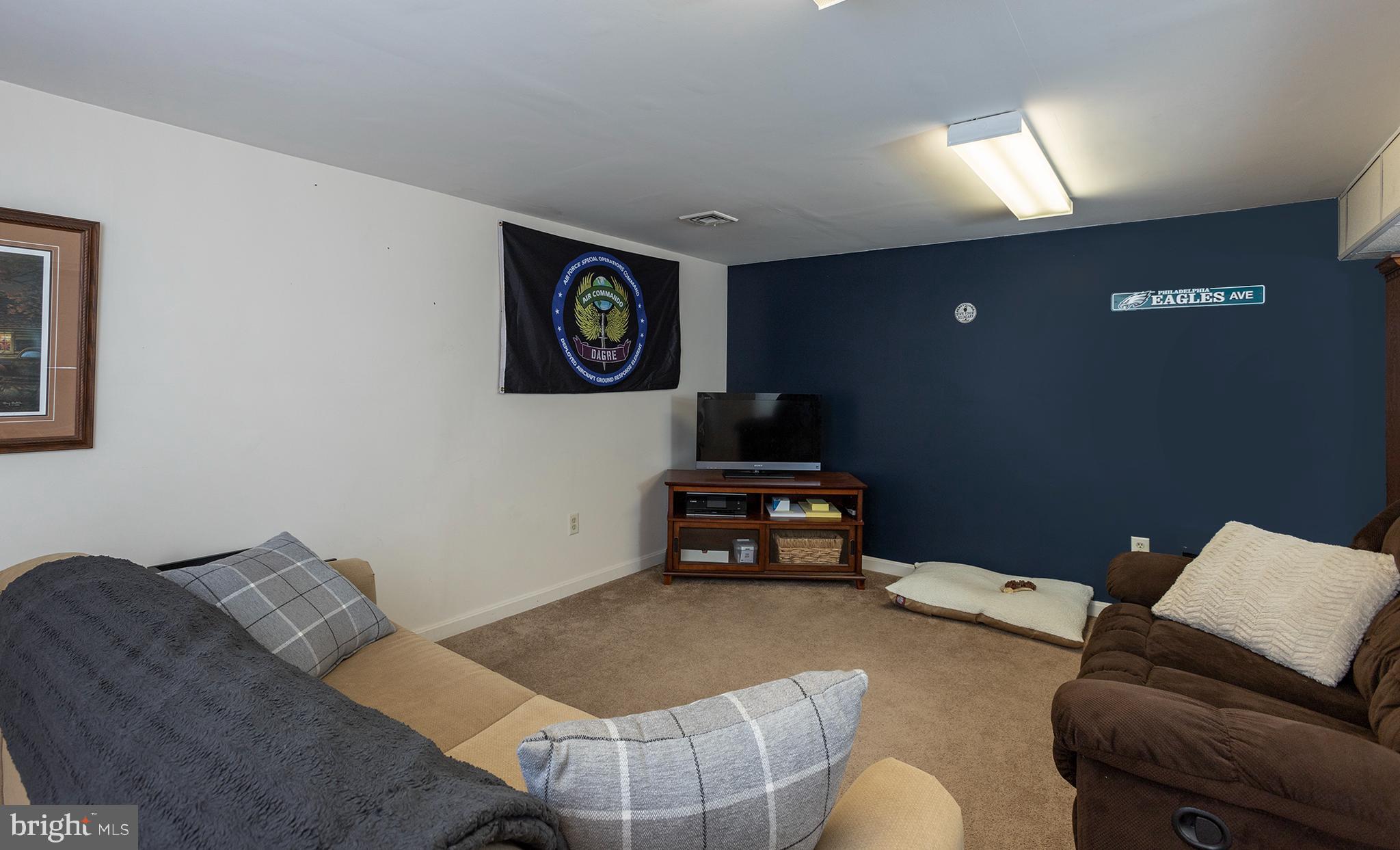 66 Runyon Road Hummelstown, PA 17036 - Photo 18 of 26 a living room with furniture and a flat screen tv