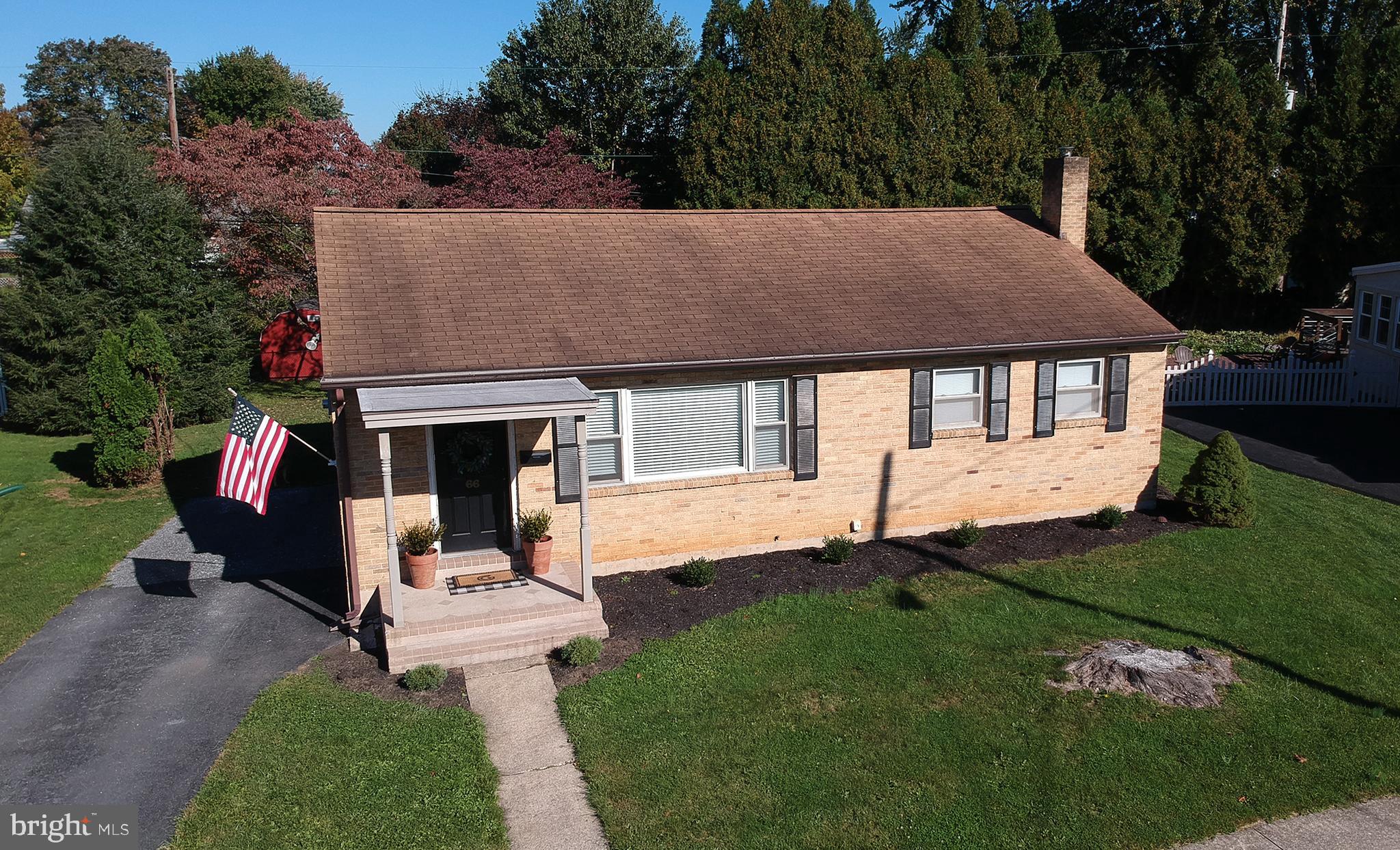 66 Runyon Road Hummelstown, PA 17036 - Photo 24 of 26 a front view of a house with a garden and yard