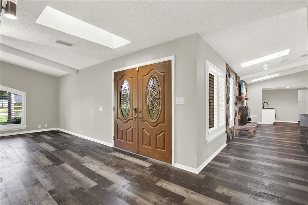 7487 River Country Drive Weeki Wachee, FL 34607 - Photo 7 of 53 an empty room with wooden floor and windows