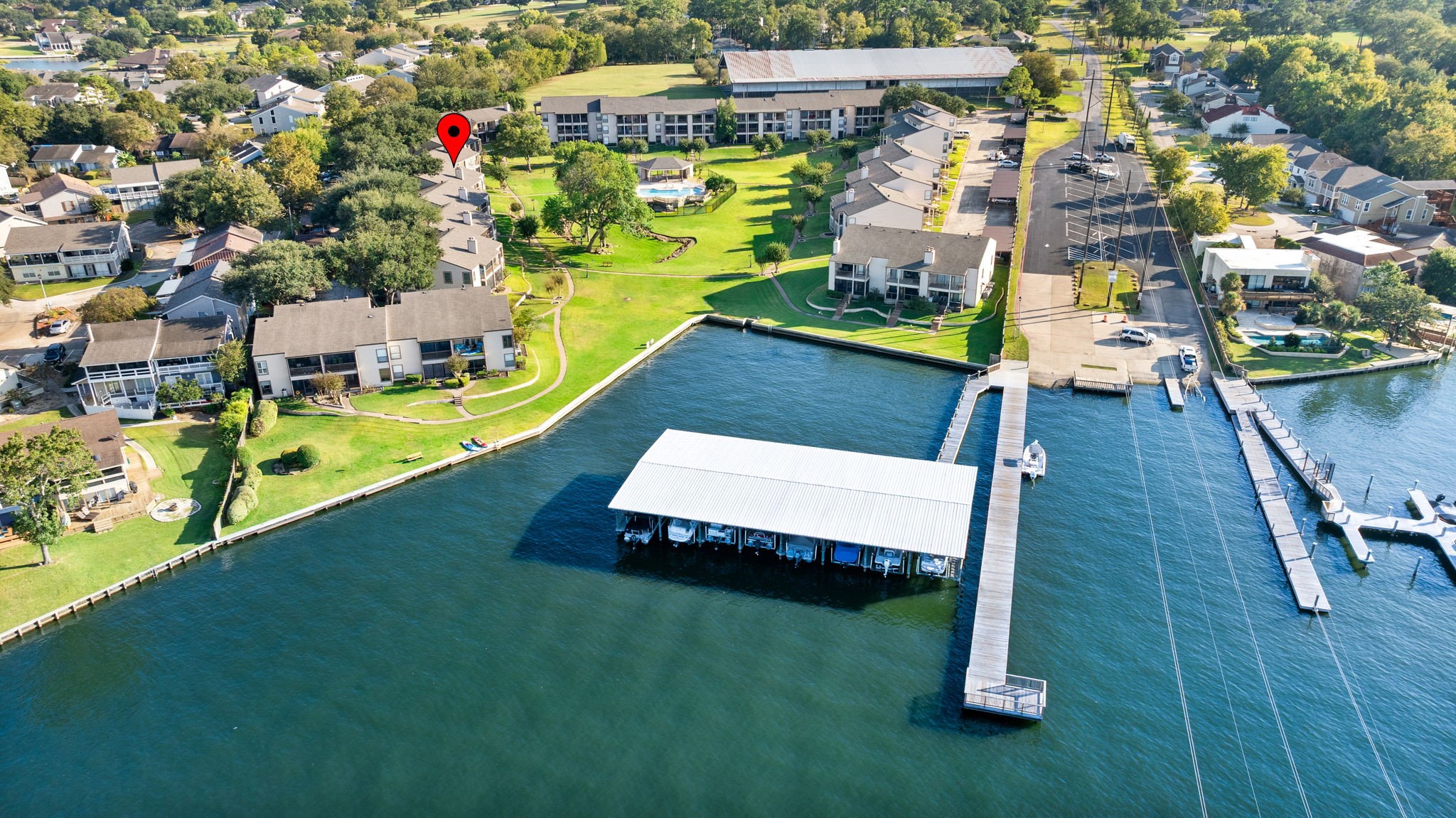 204 Lakeview Terrace, Unit G Conroe, TX 77356 - Photo 24 of 26 an aerial view of a house with swimming pool outdoor seating and yard