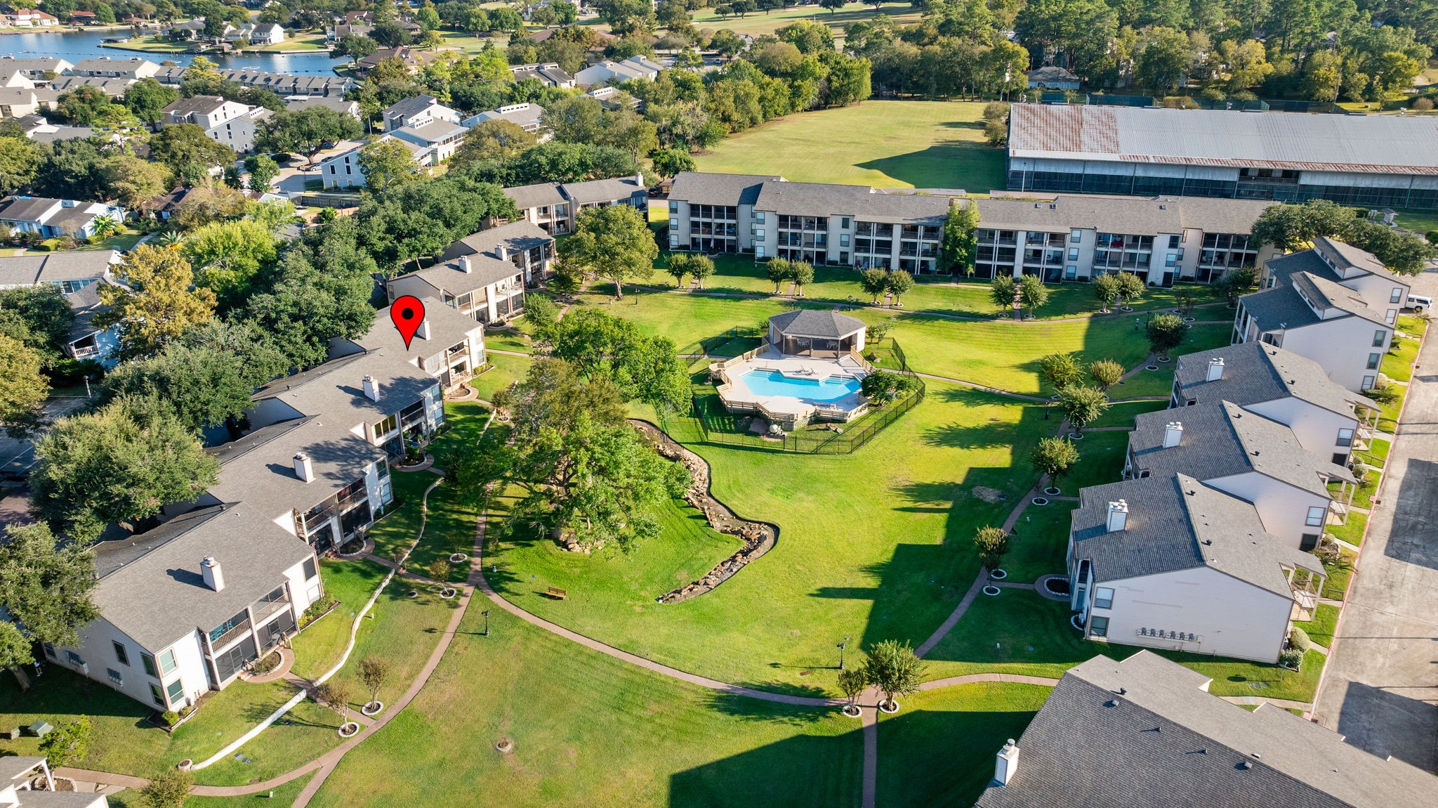 204 Lakeview Terrace, Unit G Conroe, TX 77356 - Photo 25 of 26 an aerial view of a house with outdoor space pool seating area and yard