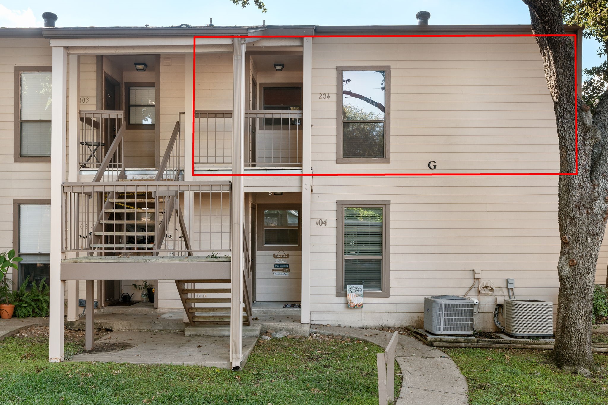 204 Lakeview Terrace, Unit G Conroe, TX 77356 - Photo 5 of 26 a front view of a house with a yard