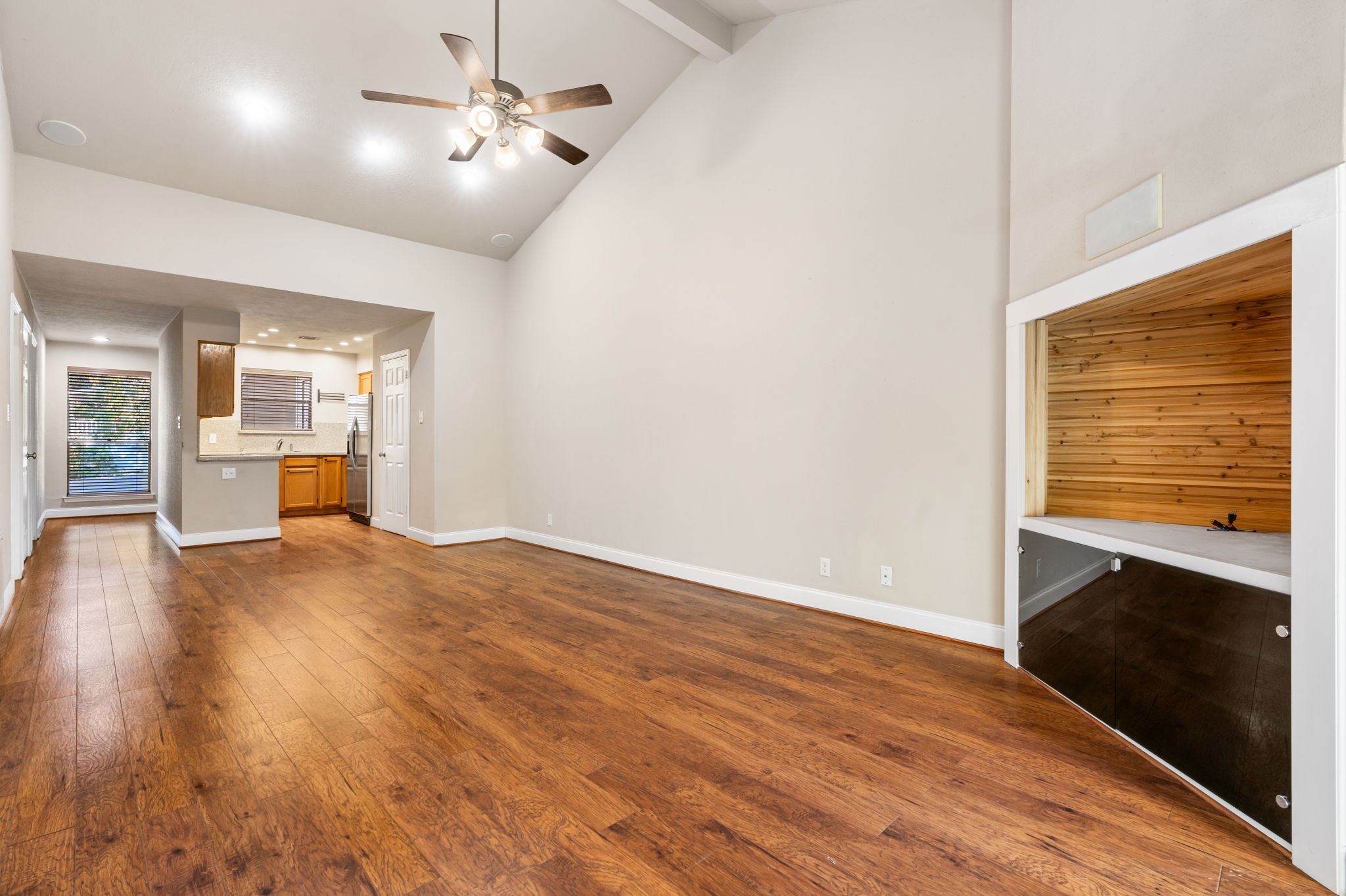 204 Lakeview Terrace, Unit G Conroe, TX 77356 - Photo 10 of 26 a view of empty room with wooden floor and fan
