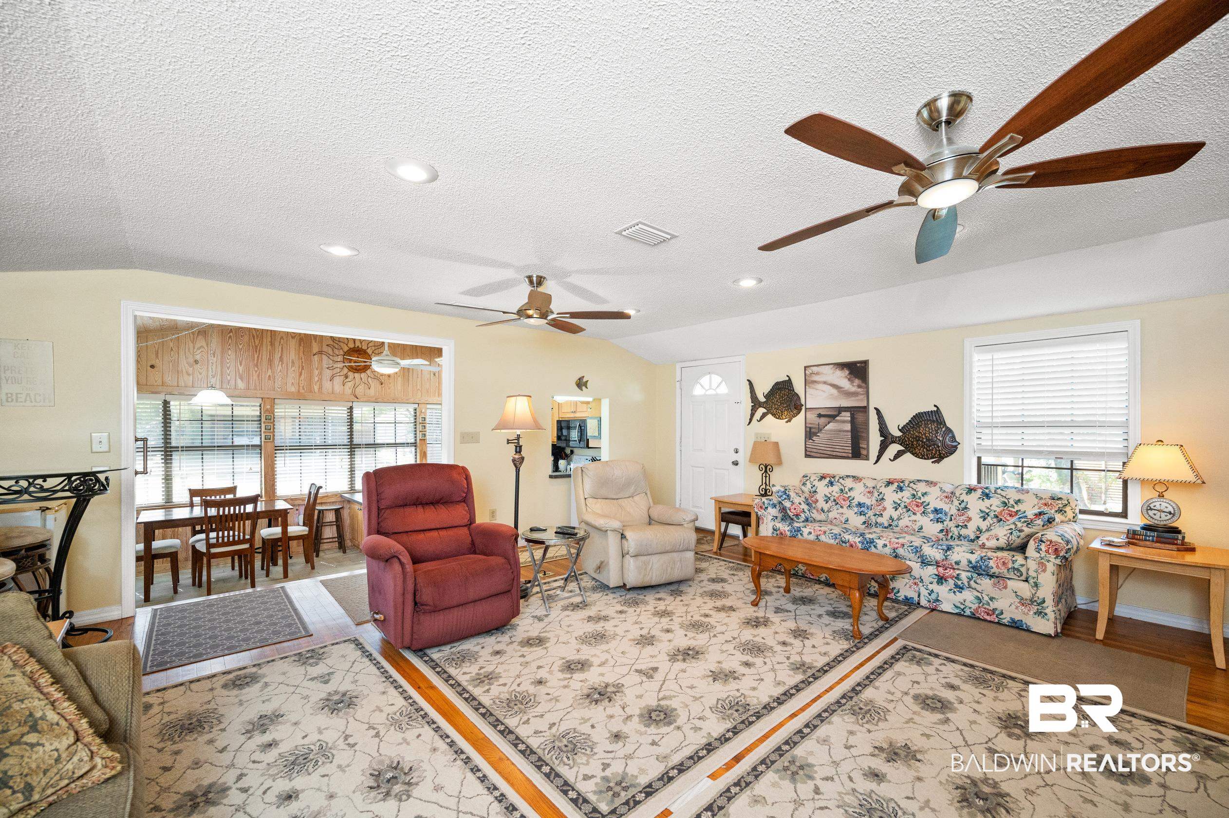 5392 Ornacor Avenue Orange Beach, AL 36561 - Photo 15 of 48 Living room with a wealth of natural light, vaulted ceiling, light hardwood / wood-style floors, and ceiling fan