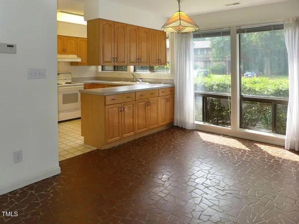 a kitchen with a sink cabinets and window