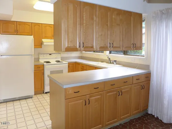a kitchen with a sink stove and refrigerator