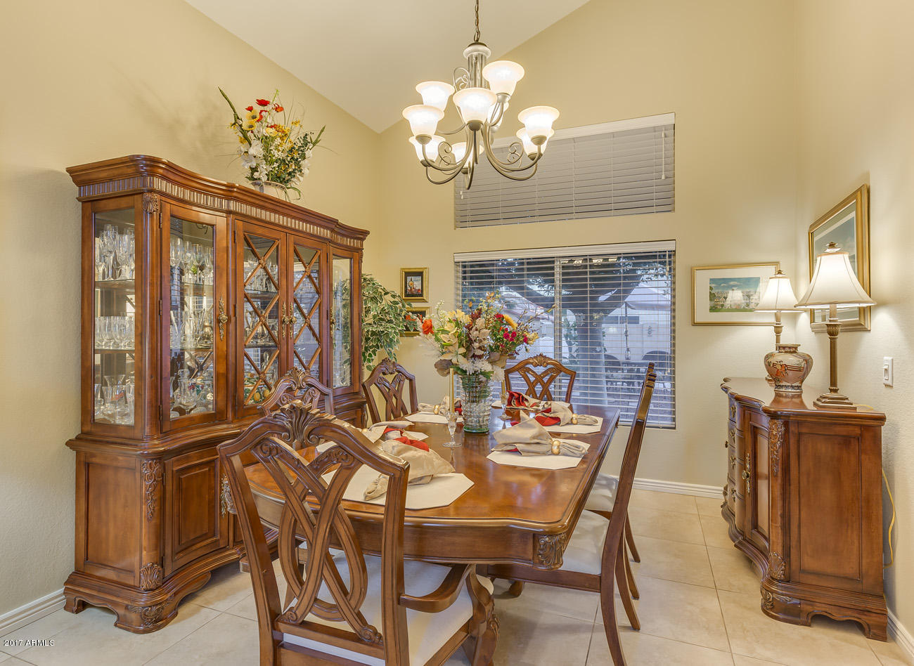 11255 West Piccadilly Road Avondale, AZ 85392 - Photo 11 of 29 a view of a dining room with furniture a chandelier and wooden floor