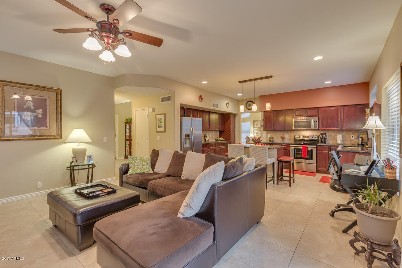 11255 West Piccadilly Road Avondale, AZ 85392 - Photo 15 of 29 a living room with furniture kitchen view and a chandelier