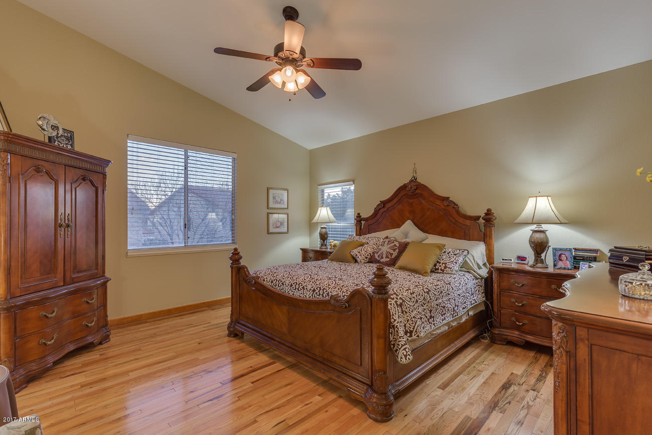 11255 West Piccadilly Road Avondale, AZ 85392 - Photo 18 of 29 a bedroom with a bed chandelier and a window