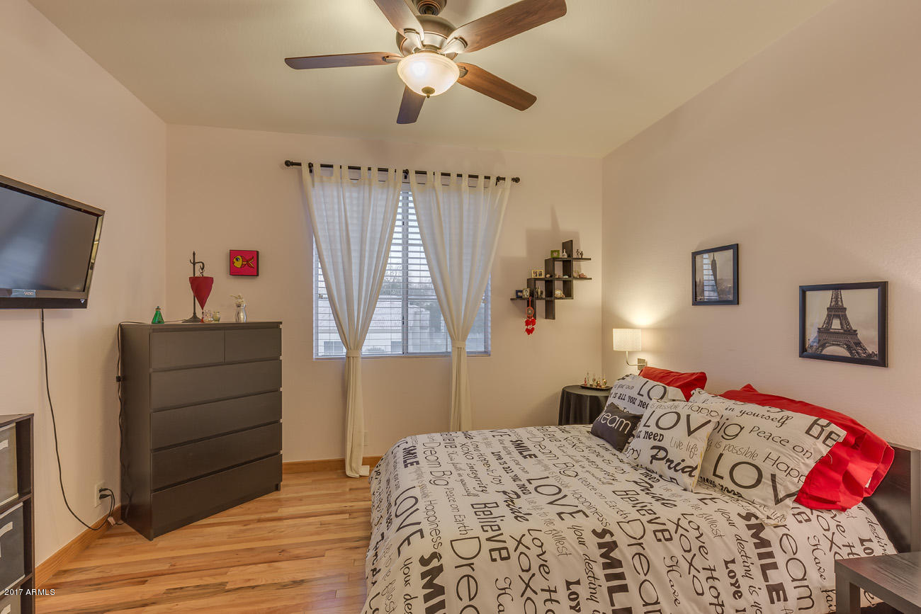 11255 West Piccadilly Road Avondale, AZ 85392 - Photo 21 of 29 a bedroom with a bed and a flat screen tv