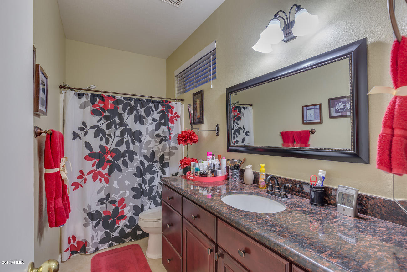 11255 West Piccadilly Road Avondale, AZ 85392 - Photo 23 of 29 a bathroom with a sink vanity mirror and shower