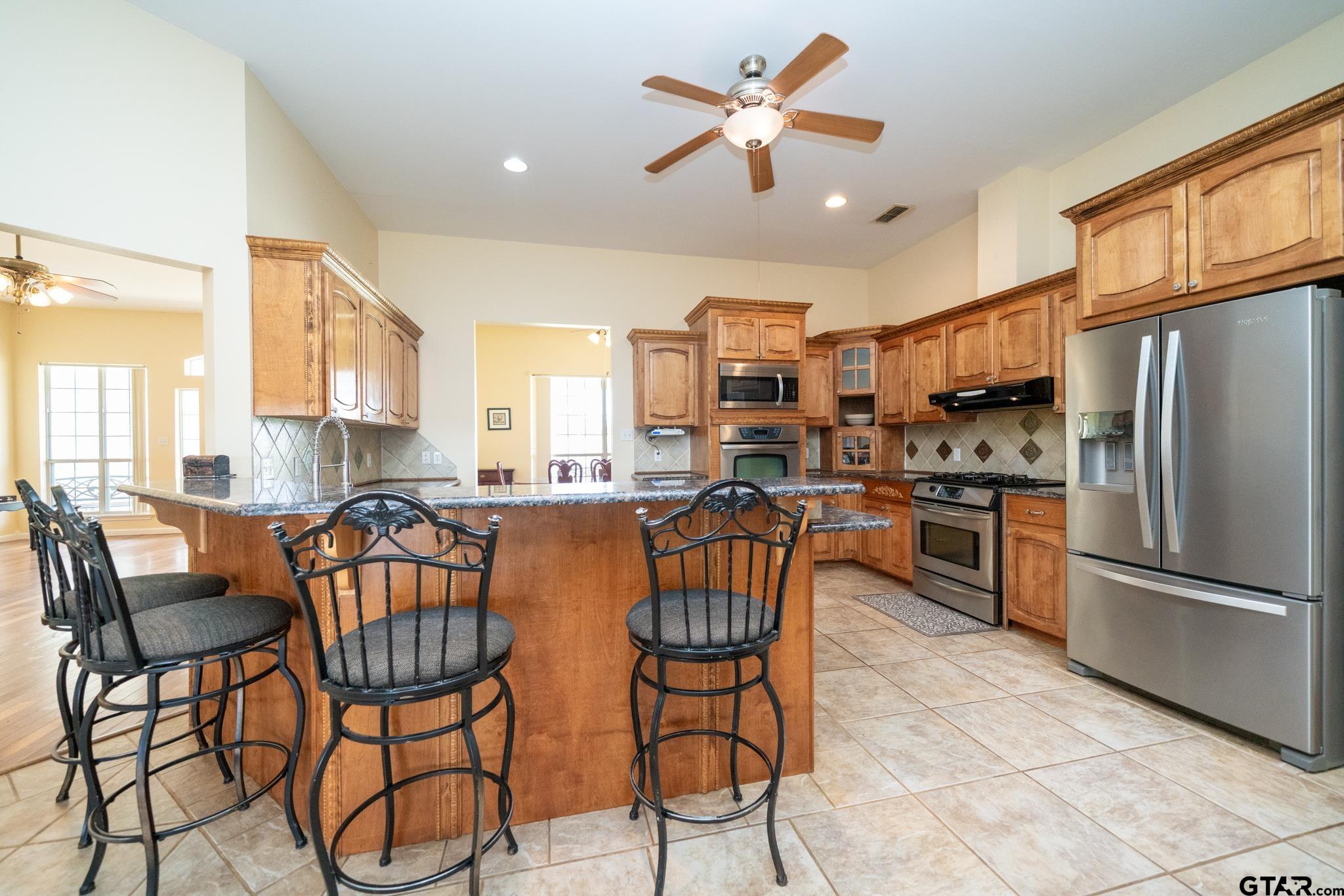 2266 Big Woods Road Longview, TX 75605 - Photo 11 of 48 a view of a dining room with furniture a kitchen and chandelier