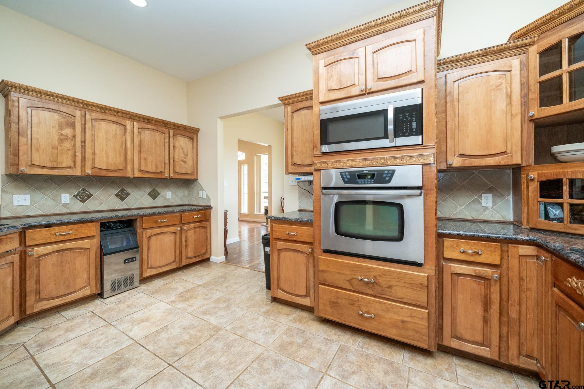 2266 Big Woods Road Longview, TX 75605 - Photo 14 of 48 a kitchen with stainless steel appliances granite countertop a stove and a microwave