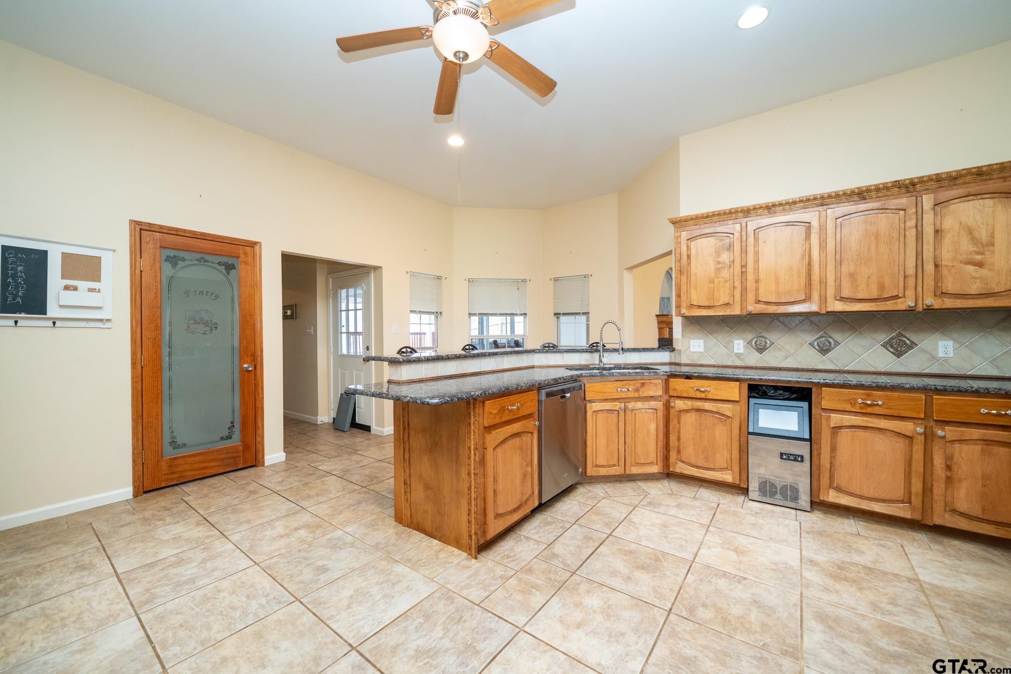 2266 Big Woods Road Longview, TX 75605 - Photo 16 of 48 a large kitchen with stainless steel appliances granite countertop a stove sink and cabinets