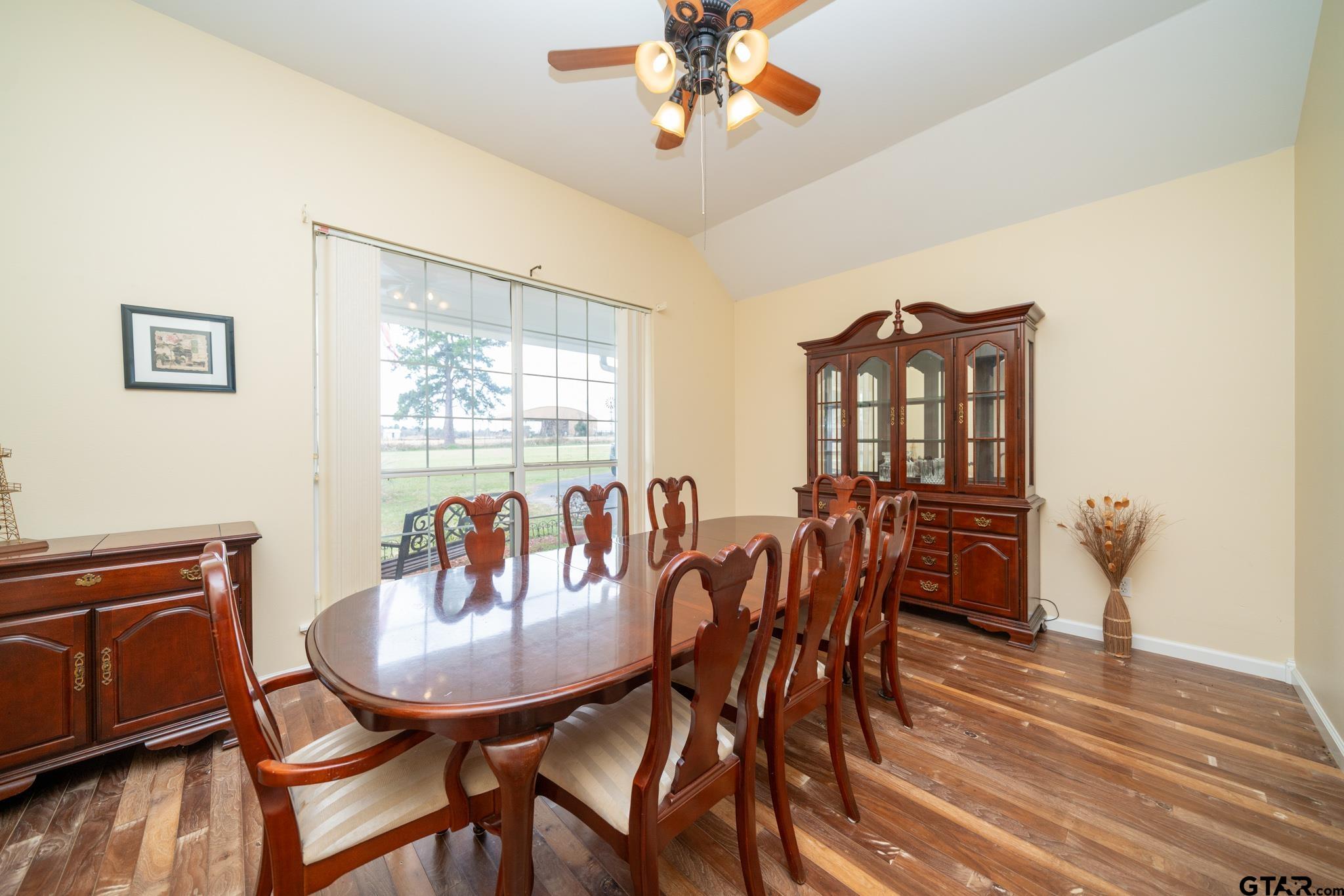 2266 Big Woods Road Longview, TX 75605 - Photo 19 of 48 a view of a dining room with furniture window and wooden floor