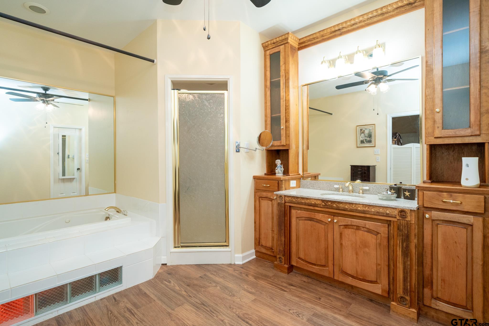 2266 Big Woods Road Longview, TX 75605 - Photo 26 of 48 a spacious bathroom with a tub sink shower and mirror