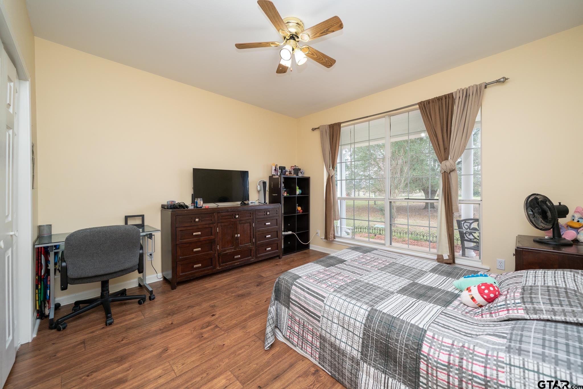 2266 Big Woods Road Longview, TX 75605 - Photo 27 of 48 a bedroom with a bed and a flat screen tv