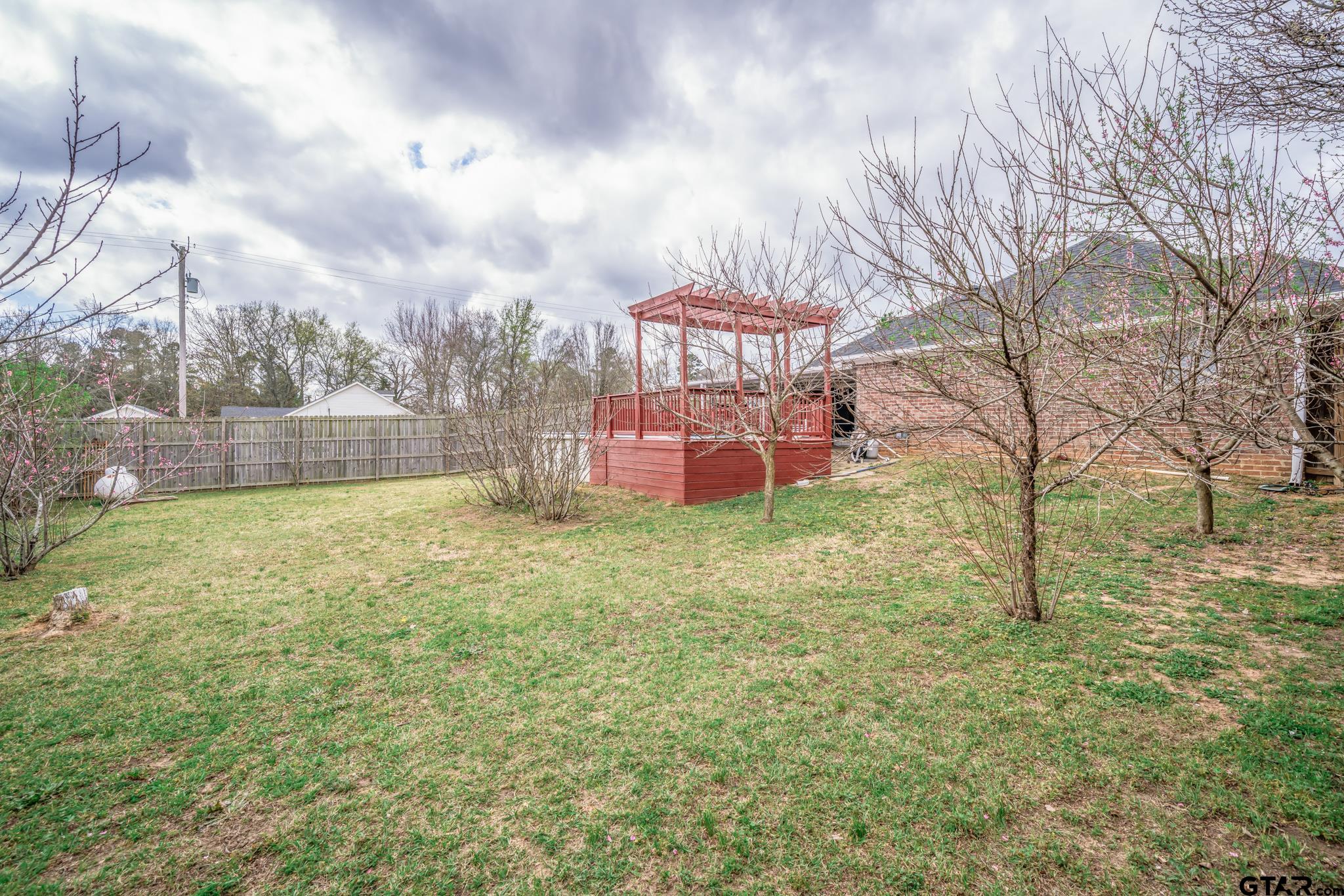 2266 Big Woods Road Longview, TX 75605 - Photo 39 of 48 a backyard of a house with table and chairs