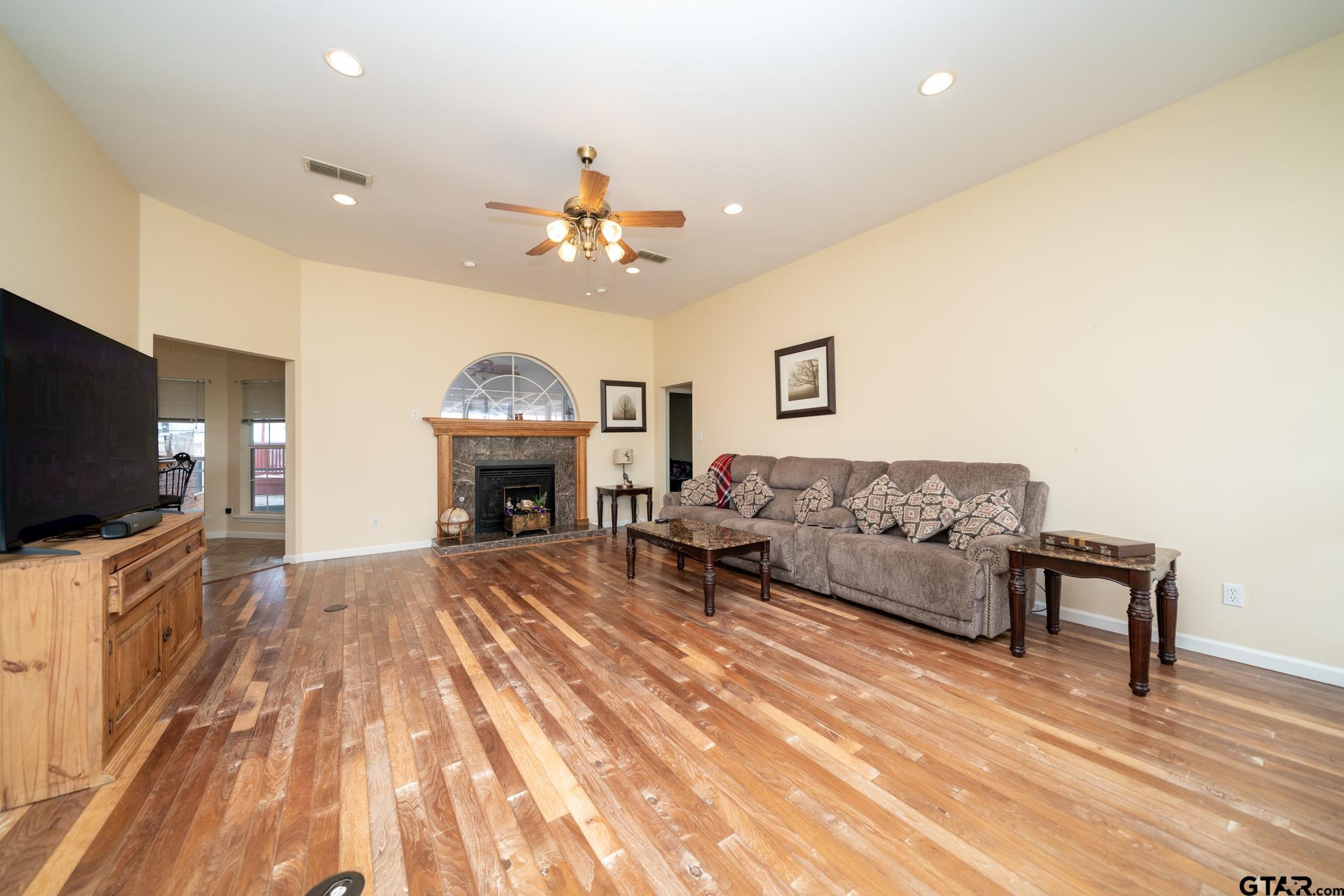 2266 Big Woods Road Longview, TX 75605 - Photo 10 of 48 a spacious bedroom with a bed and a flat screen tv