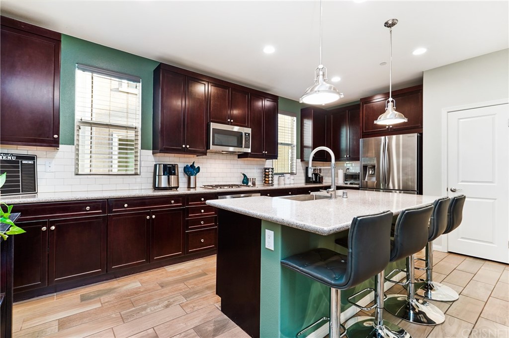 14865 West Maple Terrace Panorama City, CA 91402 - Photo 12 of 36 a kitchen with kitchen island granite countertop a sink counter top space appliances and a window