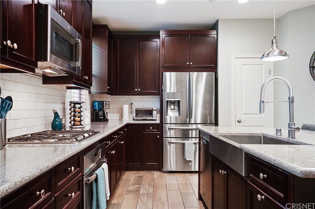 14865 West Maple Terrace Panorama City, CA 91402 - Photo 14 of 36 a kitchen with stainless steel appliances granite countertop a sink stove and refrigerator