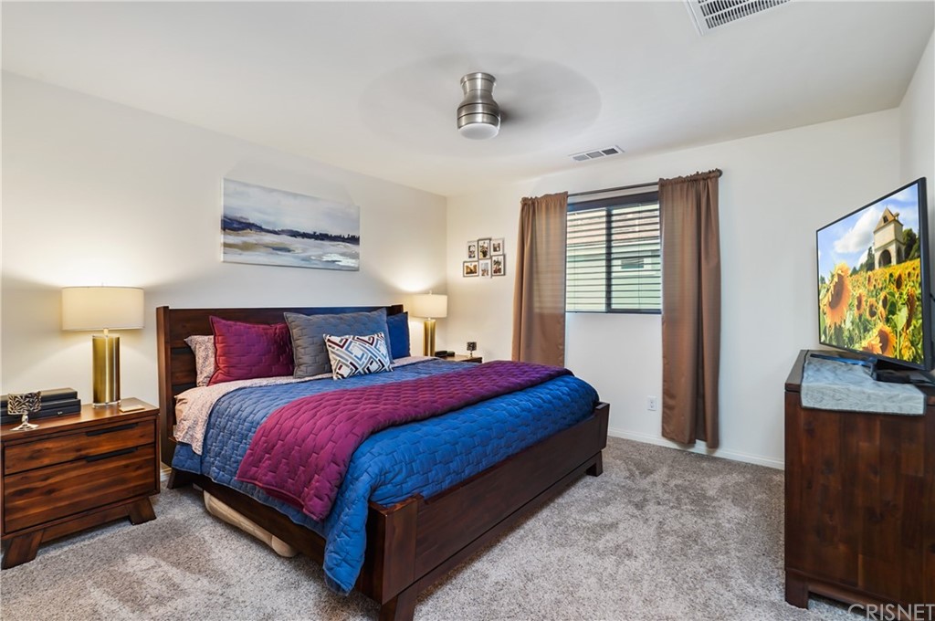 14865 West Maple Terrace Panorama City, CA 91402 - Photo 20 of 36 a bedroom with a bed and a flat tv screen on dresser