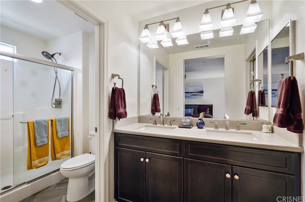 14865 West Maple Terrace Panorama City, CA 91402 - Photo 21 of 36 a bathroom with a sink vanity mirror and toilet