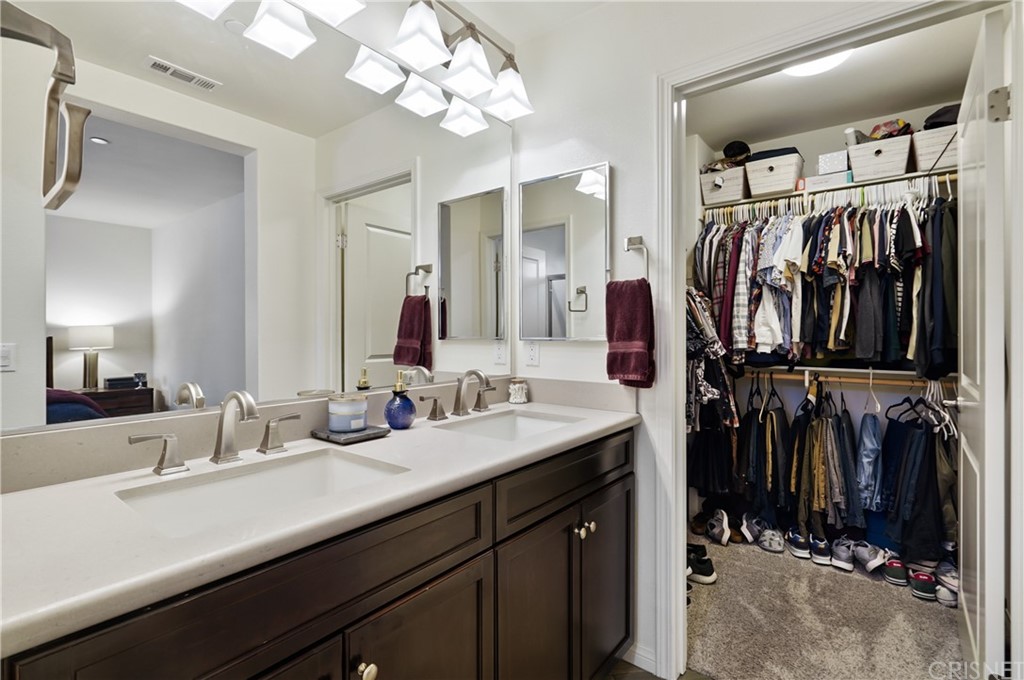 14865 West Maple Terrace Panorama City, CA 91402 - Photo 23 of 36 a bathroom with a double vanity sink a mirror and shower