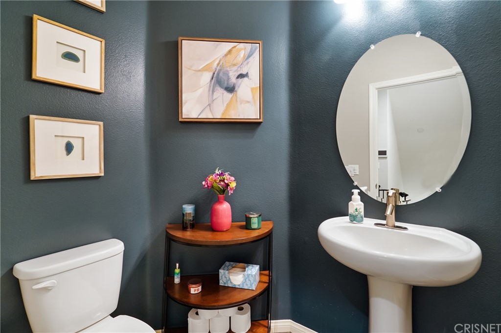 14865 West Maple Terrace Panorama City, CA 91402 - Photo 7 of 36 a bathroom with a toilet a sink and a mirror