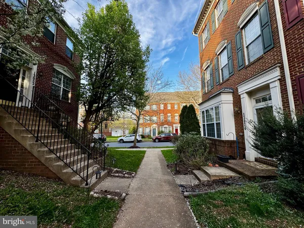 a view of a brick building next to a yard