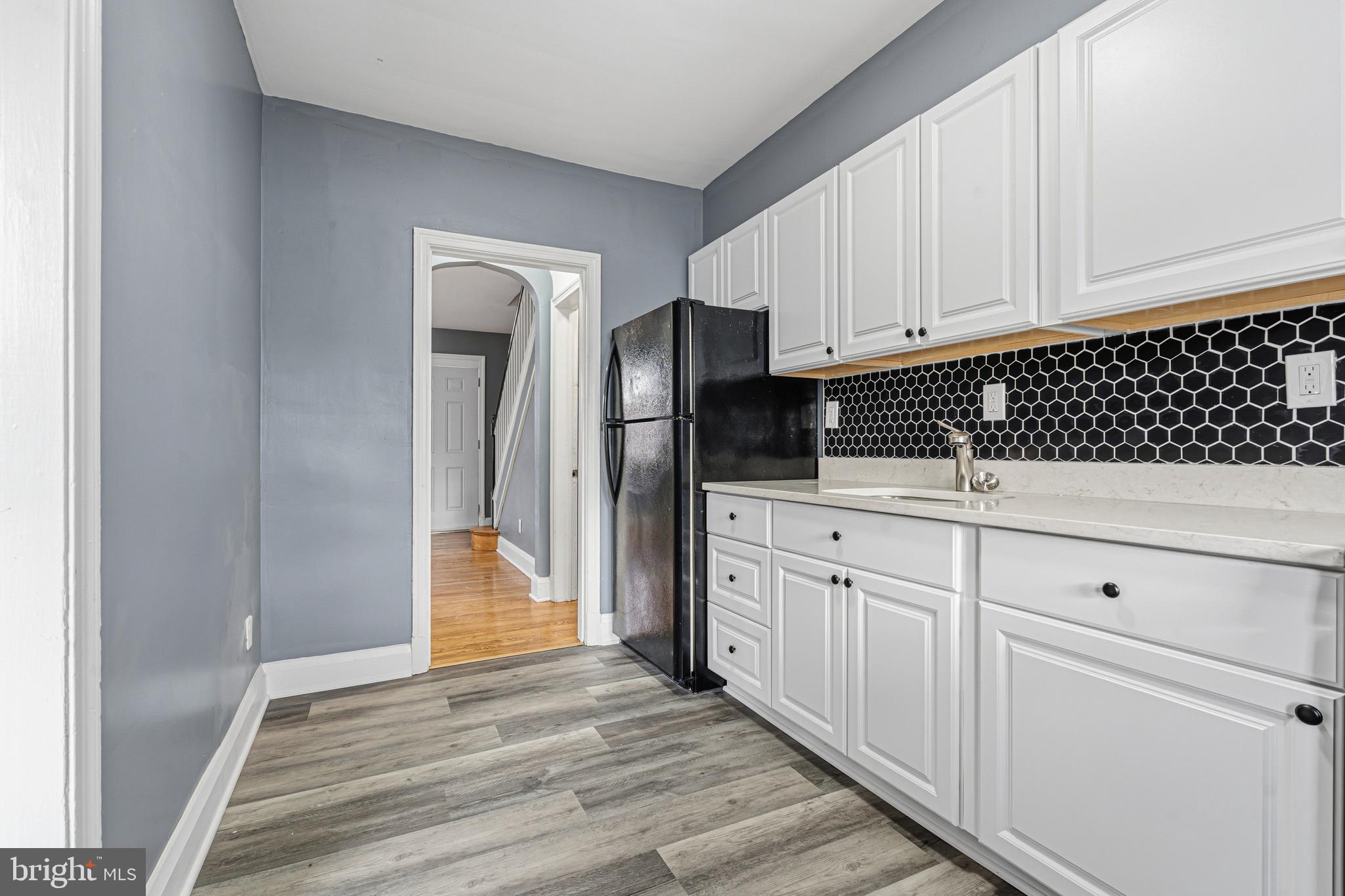 2410 Keyway Dundalk, MD 21222 - Photo 11 of 34 a kitchen with white cabinets and appliances