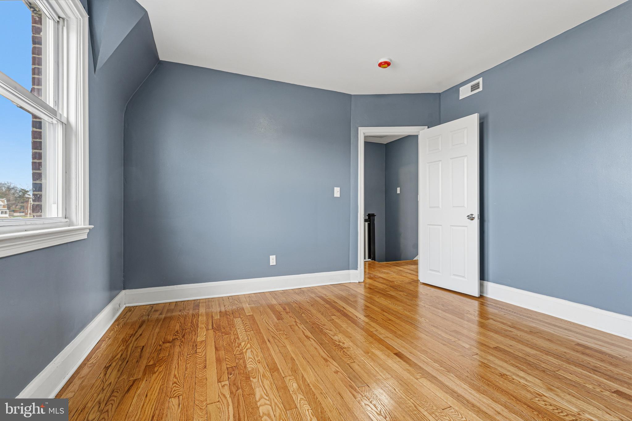 2410 Keyway Dundalk, MD 21222 - Photo 16 of 34 a view of an empty room with wooden floor and a window