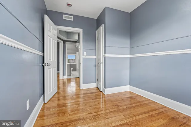 a view of entryway and hall with wooden floor