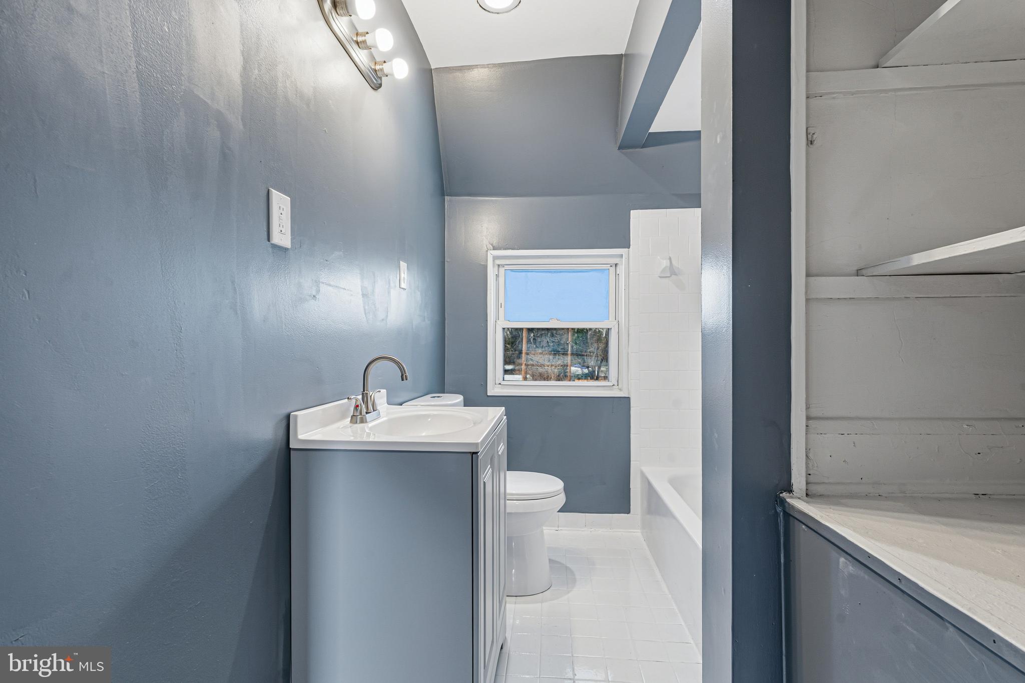 2410 Keyway Dundalk, MD 21222 - Photo 21 of 34 a bathroom with a sink a toilet and mirror