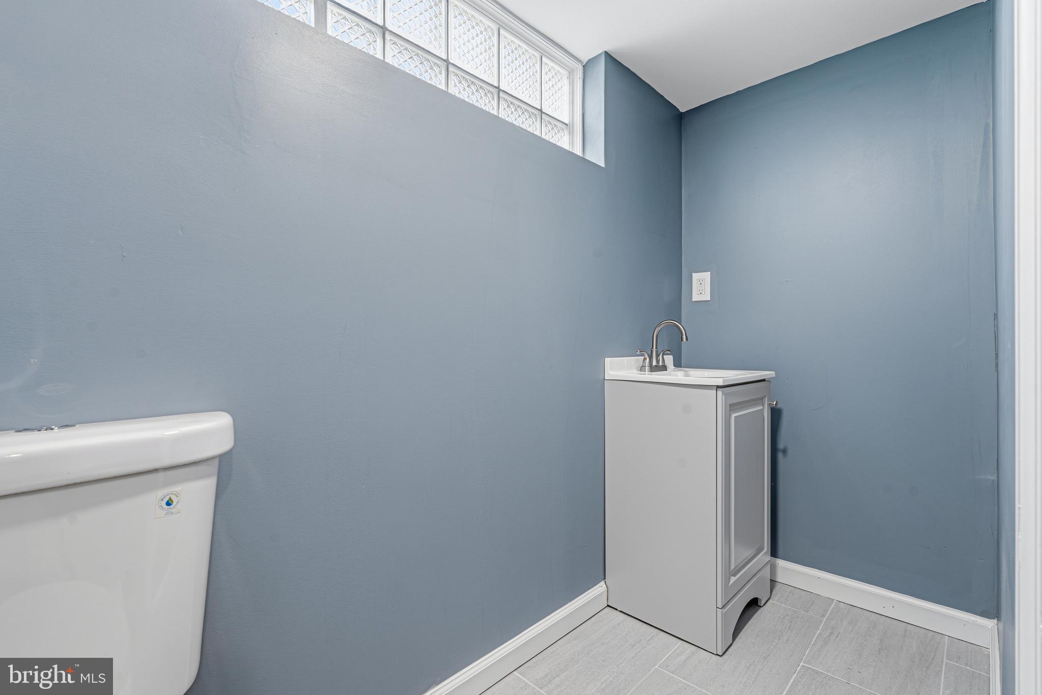 2410 Keyway Dundalk, MD 21222 - Photo 27 of 34 a utility room with a sink a toilet and a shower