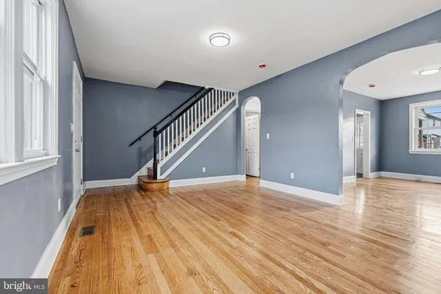 a view of empty room with wooden floor
