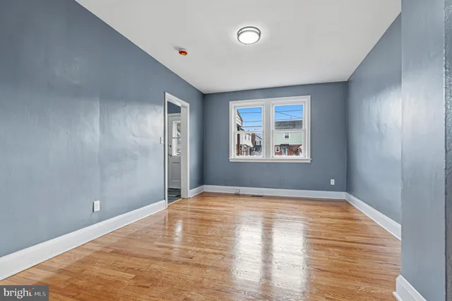 a kitchen with white cabinets and appliances