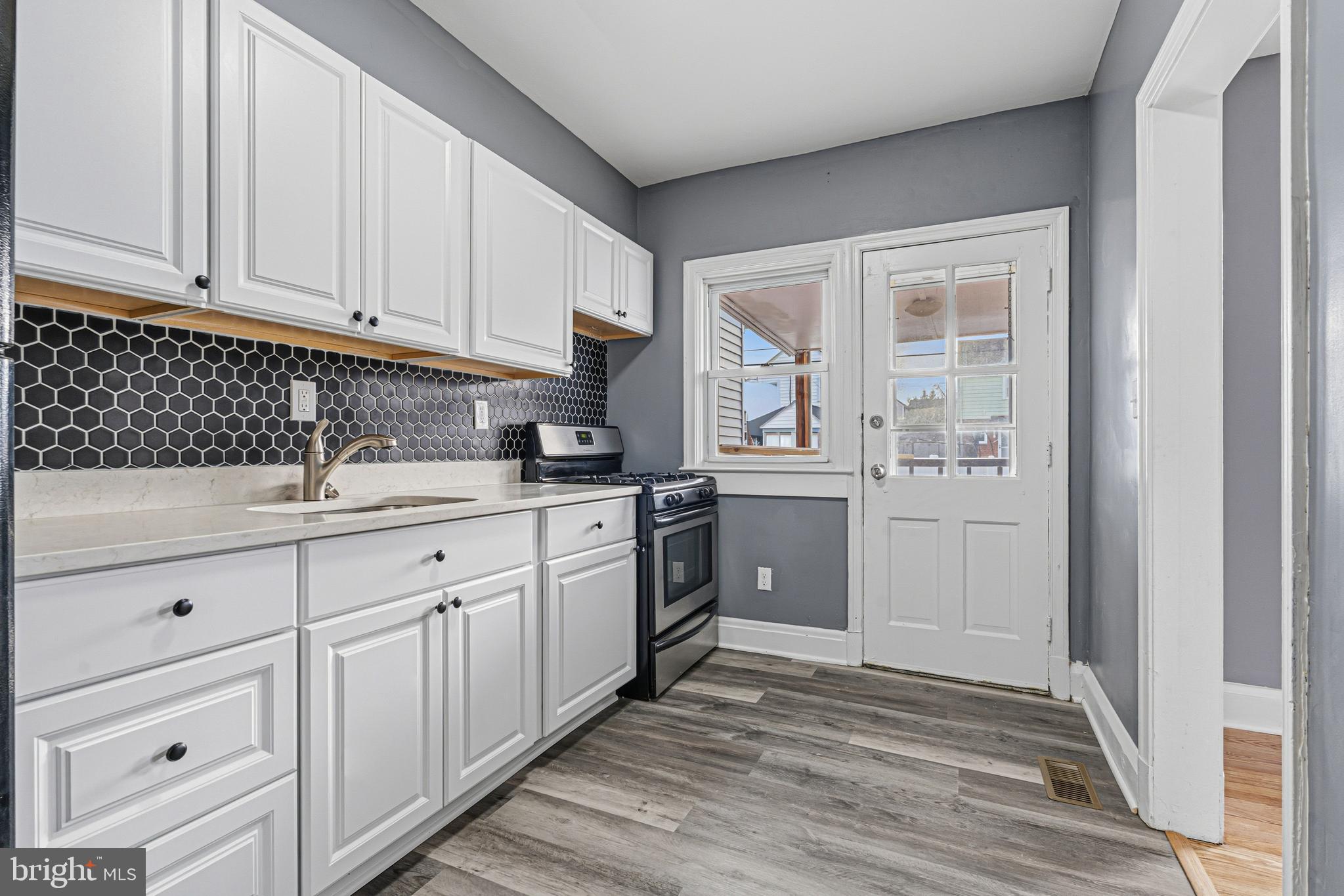 2410 Keyway Dundalk, MD 21222 - Photo 10 of 34 a kitchen with granite countertop white cabinets and white appliances