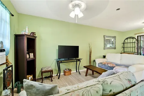a living room with furniture a flat screen tv and a table