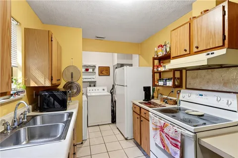 a kitchen with a sink stove and refrigerator