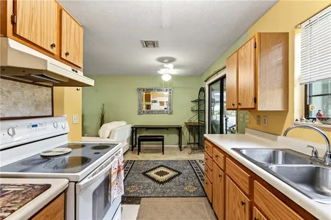 a kitchen with a stove a sink and a refrigerator