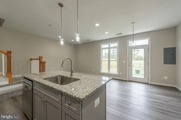 a kitchen with a sink and chandelier